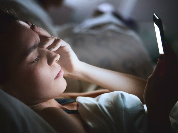Open notebook beside a warm bedside lamp
